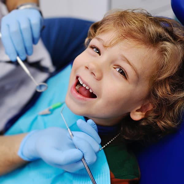 ChildinDentalChair Child at the Dentist's Office