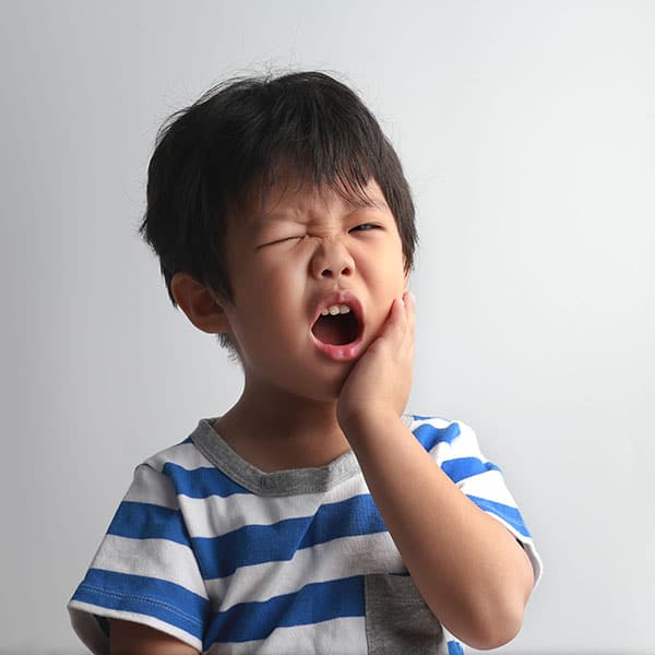 ChildwithToothPain Young Boy experiencing tooth pain.