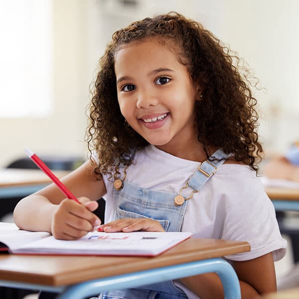 Young Girl at Her Desk in School